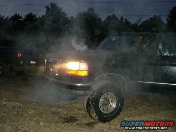 1994 Ford Bronco 3q front view with smoke and headlights on