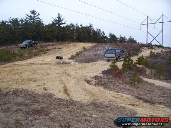 Dark SUV driving on dirt hill, 1994 Ford Bronco