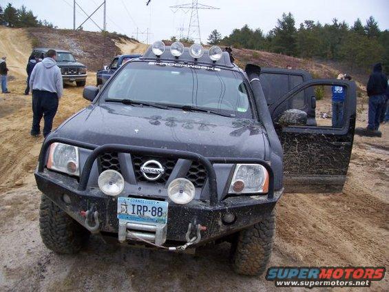 Nissan Xterra with winch, snorkel, and roof lights; Connecticut license plate IRP-88. Other vehicles and people in background