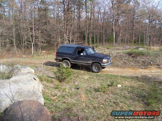 1994 Ford Bronco 3q-front view, black, on dirt road
