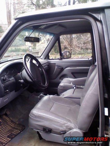 1994 Ford Bronco interior showing grey leather seats, dashboard, and steering wheel