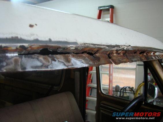 Rusted roof edge of a 1979 Ford Bronco, showing severe corrosion and damage