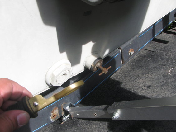 Boat hull thru-hull fitting with grounding clamp