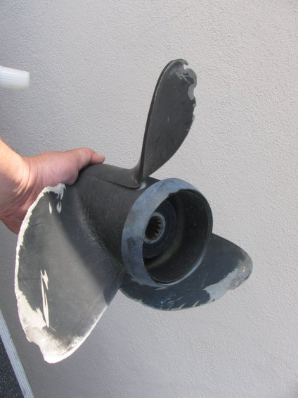 hand holding damaged boat propeller
