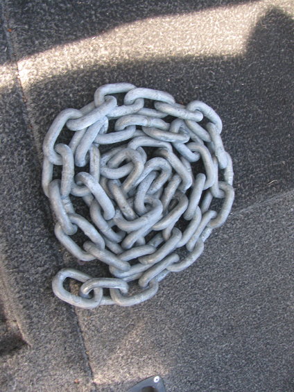 Coiled heavy-duty chain on a textured surface