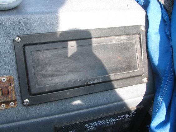 Boat dashboard with a black covered compartment and labels reading TRACKER, BILGE, AERATOR