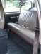 1996 Ford Bronco - Rear interior view of a 1996 Ford Bronco, showing the tan bench seat and seatbelts.