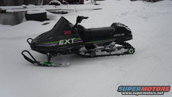 Black 1990 Arctic Cat El Tigre EXT snowmobile parked in snow