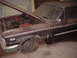 1963 Ford Galaxie - A neglected 1963 Ford Galaxie sits in a garage, showing signs of disrepair and a flat front tire.