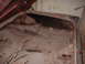 1963 Ford Galaxie - The trunk interior of a 1963 Ford Galaxie shows significant rust and deterioration.