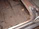 1963 Ford Galaxie - The interior floor pan of a vehicle shows significant rust and deterioration, with numerous holes and corroded metal.