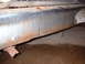 1963 Ford Galaxie - This close-up shows significant rust and damage on a vehicle's lower body panel, with a partial license plate in view.