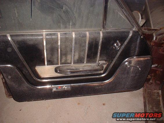 Interior door panel with chrome trim and pull handle