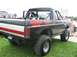 1986 Ford Bronco - Modified 1986 Ford Bronco with a roll cage and lifted suspension is displayed at a truck show.