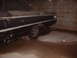 1963 Ford Galaxie - The rear of a dark-colored 1963 Ford Galaxie is visible, showing its distinctive body lines and trim.