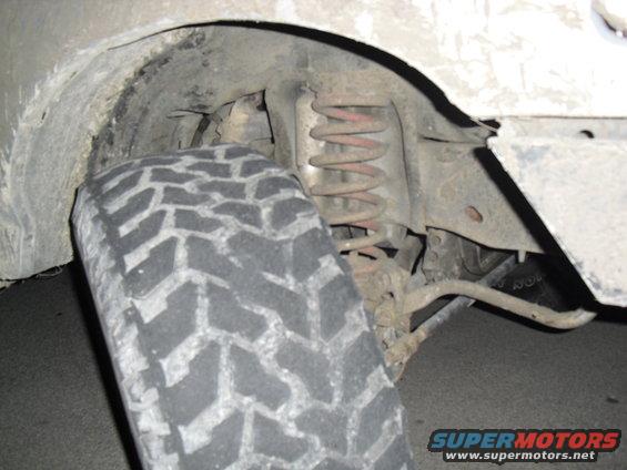 Close-up of a tire and suspension components of a vehicle