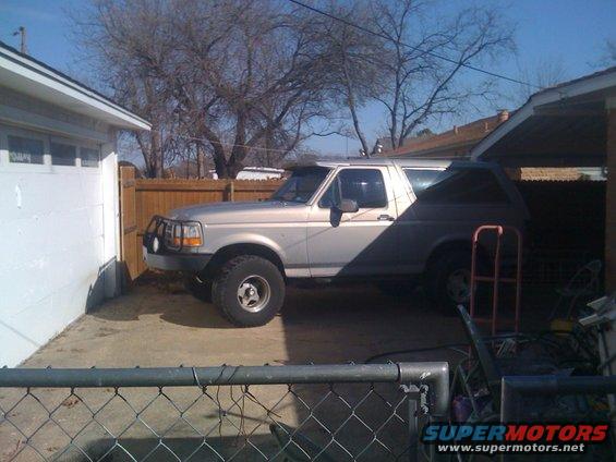 1992 Ford Bronco parked in driveway next to a garage