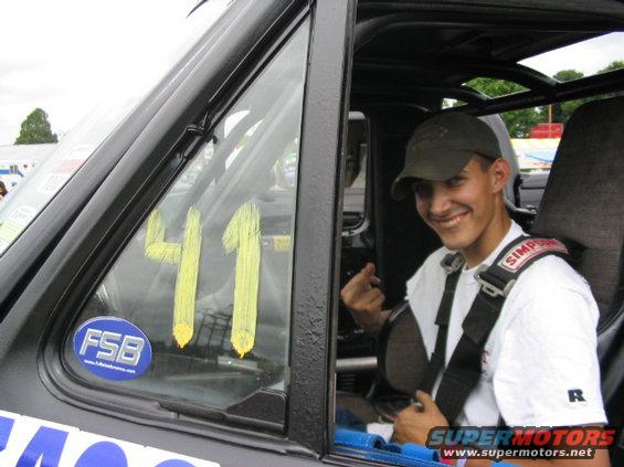 Guy in a race car with number 41 on the window and a Simpson racing harness