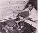 1968 Ford Mustang - A man inspects the engine compartment of a 1968 Ford Mustang, highlighting specific areas.