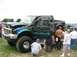 1986 Ford Bronco - Customized Ford F-250 truck on display at an outdoor event with spectators.