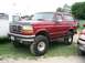 1986 Ford Bronco - This red 1986 Ford Bronco, seen at the Essex Junction Truck Show, features a lifted suspension and oversized tires.