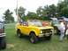 1986 Ford Bronco - Yellow 1986 Ford Bronco at a truck show with other vehicles and people around.