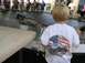 1986 Ford Bronco - A child watches toy trucks race on a track at an event.