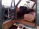 1990 Ford Bronco - Interior view of a 1990 Ford Bronco, driver's side door panel removed, showing worn seat upholstery.