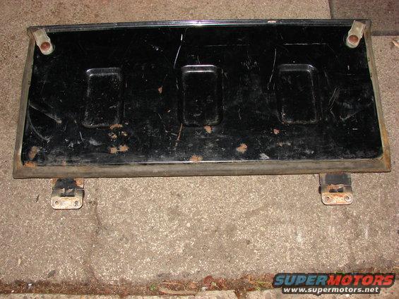 Black Jeep CJ tailgate with three rectangular indentations, mounted on hinges