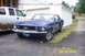 1967 Ford Mustang - 1967 Ford Mustang coupe in blue, parked next to a white pickup truck in a driveway.