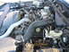 1997 Ford Crown Victoria - The engine bay of a vehicle is shown with various mechanical parts and wiring.