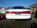 1997 Ford Crown Victoria - Rear view of a white 1997 Ford Crown Victoria, doors open, parked outdoors.