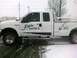 2005 Suzuki GSX-R 1000 - Side view of a white Ford F-series pickup truck with company logos, seen during snowfall.