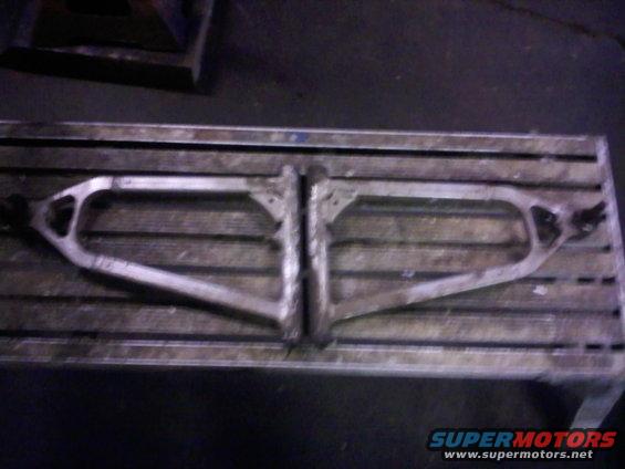 Pair of ATV A-arms on a metal table