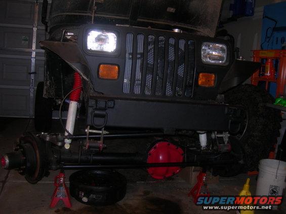 Front of a 1991 Jeep Wrangler on jack stands with suspension components visible