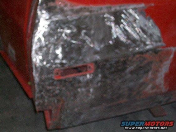 100_0345.jpg lousy picture, but the right rear quarter had been poorly repaired previously; it looks like they probably backed into something. Instead of banging out the dents, they just punched a bunch of holes and filled it with about 3/8" of bondo; we fixed it right by removing all the bondo, straightening it out, welding up the holes and just a skim coat of kitty hair bondo.