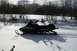 1990 Arctic Cat El Tigre EXT - A black snowmobile with EXT graphics sits in the snow, with trees in the background.