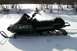 1990 Arctic Cat El Tigre EXT - Side view of a 1990 Arctic Cat El Tigre EXT snowmobile in a snowy landscape.