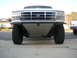 1988 Ford Bronco - Front view of a white Ford truck, likely a 1992-1997 model, a prominent aftermarket skid plate.