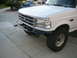 1988 Ford Bronco - This Ford F-Series truck features a chrome grille and a custom front bumper.
