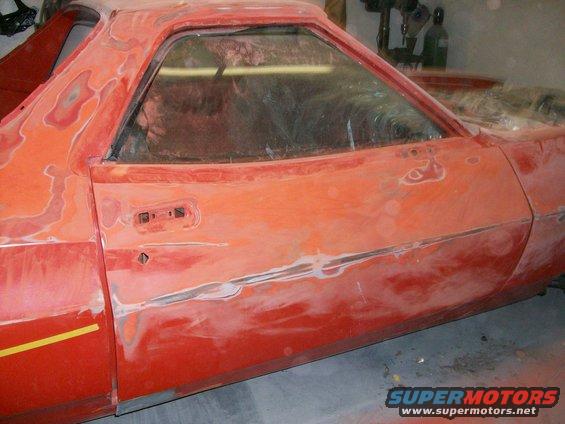 there is three coats of paint on the back half of the car, and four on the front half; it was red originally, then a loud orange and then the current orange.

the front half of the car had a coat of clear on it, but the back half was only single stage. 

I'm sanding off at least two coats of paint with a long board by hand! 