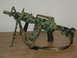 1989 Ford Bronco - A toy assault rifle with a camouflage pattern and a bipod is displayed on a wooden surface.