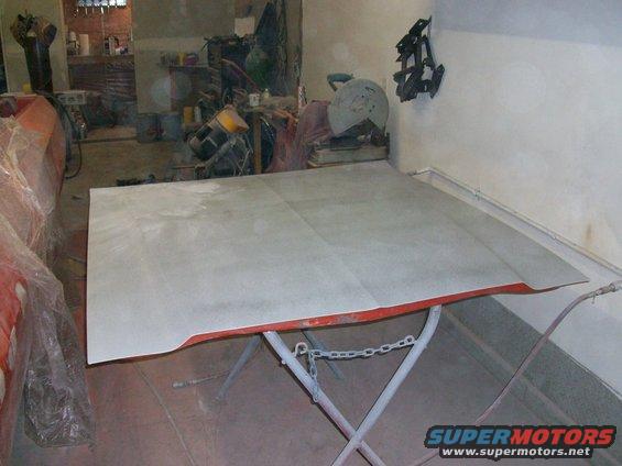 100_0379.jpg we layed on two coats of primer on the hood, then blocked-sanded it.