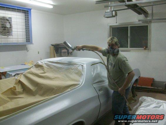 100_0393.jpg Kim is laying on the first coat of Omni MH283 hi-build primer; he'll put on two coats, most of which we will sand off.