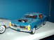 1978 Ford Mustang II - A blue toy car with a black hood scoop sits next to another toy car on a shelf.