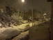 2007 Subaru Impreza - A street scene at night during a snowstorm, with multiple vehicles covered in snow.