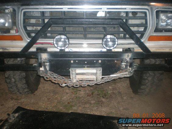 Front of a Ford truck with a winch, brush guard, and two lights. It looks like a 1980s model