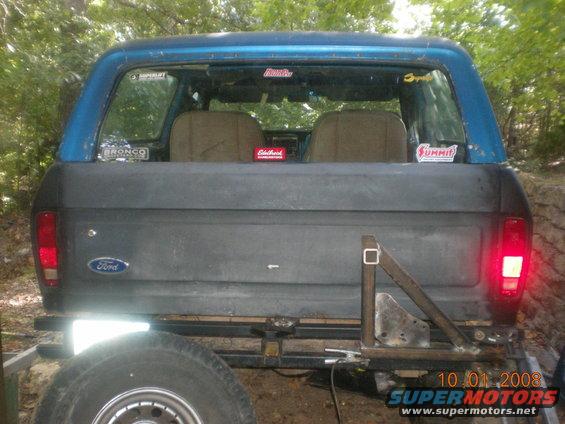 Blue and gray Ford Bronco rear view with "Bronco" sticker on rear window