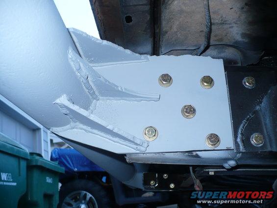 Undercarriage bracket bolted to frame, part of a vehicle's rear bumper assembly