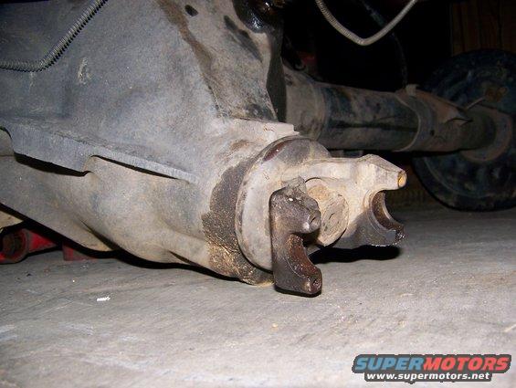 Rear axle differential with a broken U-joint yoke, resting on a concrete floor